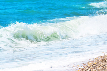 Obraz premium Picturesque sea landscape, wave, white foam. Natural waves and beach