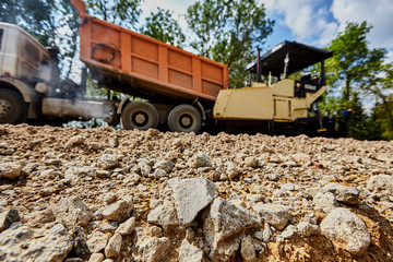 Construction of a road with rubble and sand and a truck