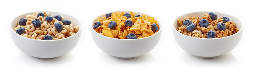 Three bowls of cereals with blueberries isolated on white