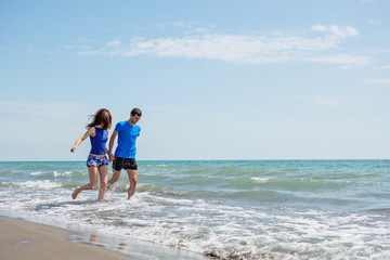 Young happy couple on seashore