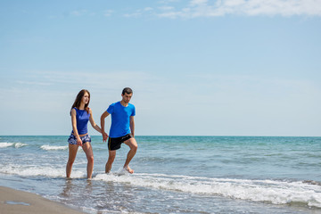 Young happy couple on seashore