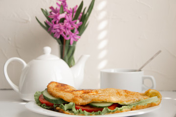 Breakfast with coffe and sandwich with vegetables