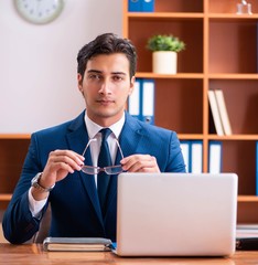 Young handsome businessman working in the office