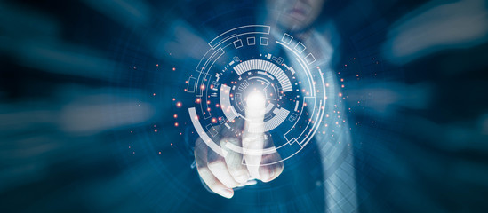 Business people are pointing at the technology circle Which is like the future There is light on the finger. Technology concepts for the future on a black scene.