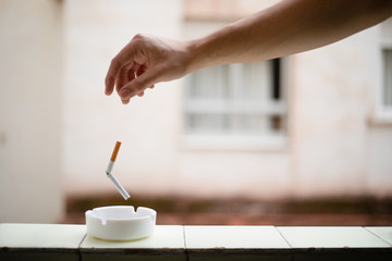 Hand pulling a broken cigar because it has stopped smoking