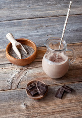 Oat milk with chia seeds and chocolate for breakfast on a wooden background. Proper nutrition concept.