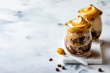 Dalgona coffee chocolate chia pudding. Fluffy creamy whipped trend coffee foam dessert. Trendy food...