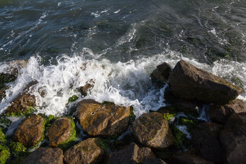 Waves breaking onto a stony seashore.
