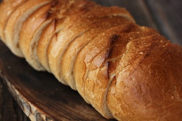 Delicious fresh loaf on a wooden table 
