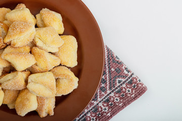 Crispy cottage cheese cookies lies on a brown plate