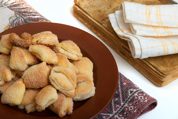 Crispy cottage cheese cookies lies on a brown plate