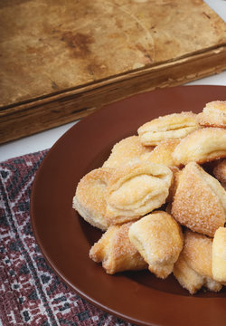 Crispy cottage cheese cookies lies on a brown plate