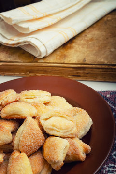 Crispy cottage cheese cookies lies on a brown plate