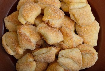 Crispy cottage cheese cookies lies on a brown plate