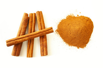  Cinnamon sticks and ground cinnamon on a white background