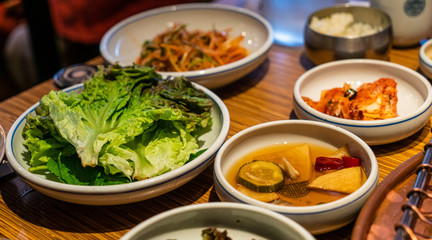 Korean barbecue sidedish with green lettuce, pickle and Kimchi
