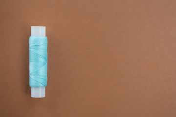  blue threads on a brown background. concept of natural fabrics and eco clothes. Top view. Mock up. Flat lay composition