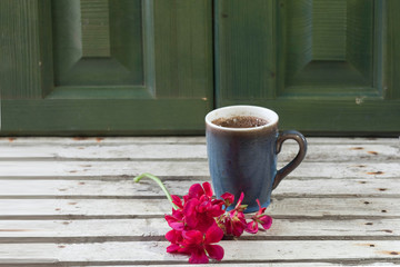 rural still life with a Cup of coffee and red flowers