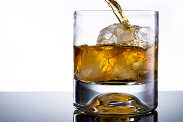 glass of whiskey with ice cubes