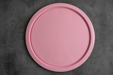 Beautiful pink plate on grey background