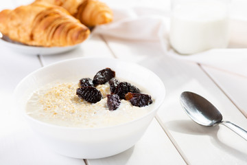 Porridge with plum  and croissants