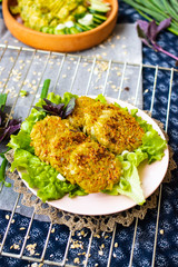 Draniki - traditional potato, onion baked or fried pancakes with lettuce salad leaves. Vegan food.