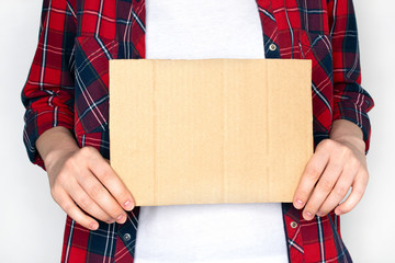 Woman in shirt hold empty cardboard. Template for text.