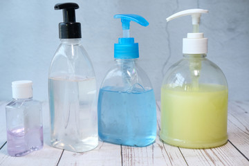 hand sanitizer and liquid soap on black background 