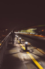 Fototapeta na wymiar Night train on bridge. Lights by night