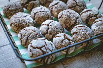 Chocolate crinkle cookies in a basket on wooden table. Top view. Landscape format.