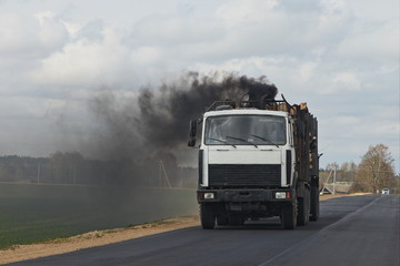 Diesel truck with black smoke from the exhaust pipe, harmful emissions from vehicles, environment damage