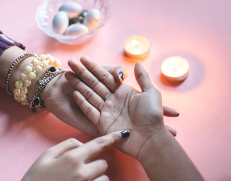 palmistry fortune teller reads lines on hand or palm to tell future. 