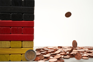 euro coins falling on colored bricks symbolisign the german flag