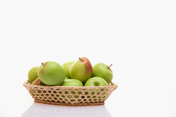 Apples and pears in a basket on a white background