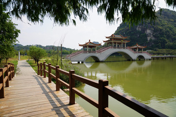 pagoda bridge across the lake in the park. Seven Stars Cave Scenic Park in Zhaoqing City 