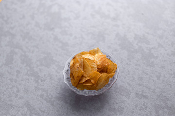Fototapeta na wymiar Fresh potato chips stock image with textured background. 