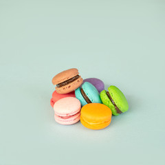Colorful macarons dessert on blue background.