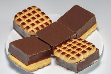 Sandwich cookies with vanilla souffle and chocolate. Sweet food from the shop.