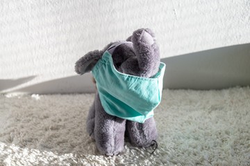 Plush elephant toy with the respirator mask on the table. Slovakia
