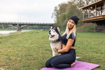 Naklejka na ściany i meble Fitness girl exercising with dog husky