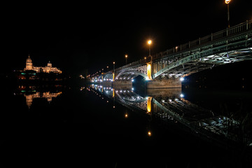 Panoramic night wide view of the historic city of Salamanca with New Cathedral and Enrique Esteban bridge. Castile and Leon in Spain.