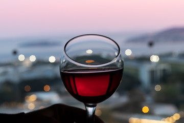 glass of wine and city lights,bokeh with landscape