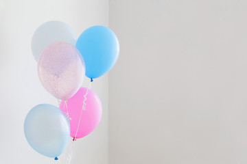 blue and pink balloons on white background