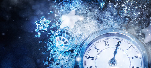 Obraz na płótnie Canvas New Year's at midnight - Old clock with stars snowflakes and holiday lights. Christmas and New Year background