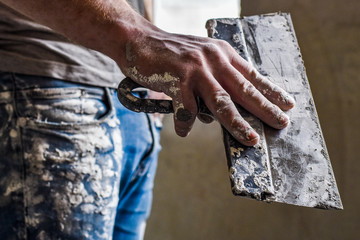 a man holds a spatula in his hand