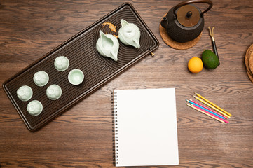 notebook and tea cup on table