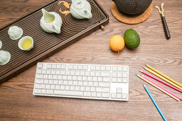 tea cup and keyboard on table