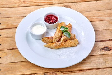 pancakes with sour cream and berry sauce