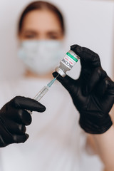 COVID-19, nCoV 2019 or Corona Virus 2019. Syringe injection and Vaccine in doctor hand, It use for...