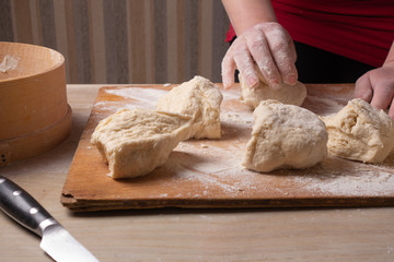 Fototapeta na wymiar Female hands mixing dough in the home kitchen.